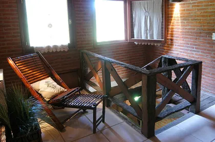 Interior rústico con ladrillos expuestos, madera y mucha luz natural — proyecto Casa Cariló 2004, por Hugo Zawadski Arquitectos, en Cariló