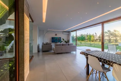 Living comedor moderno con grandes ventanales y vista rural — proyecto Casa ME, por Estudio GR, en City Bell