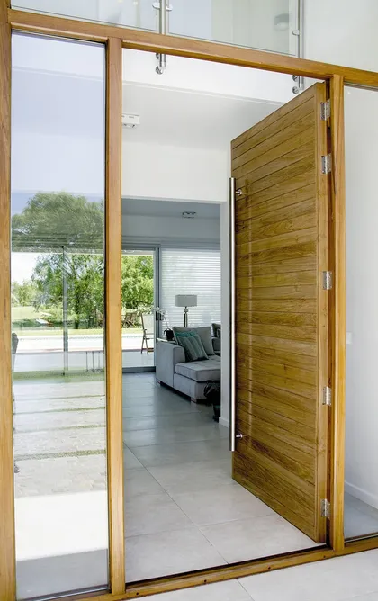 Puerta corrediza madera hacia terraza con vistas al jardin y exterior — proyecto Casa 13, por Parrado Arquitectura