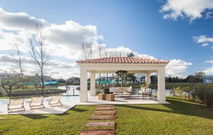 Galeria mediterranea con pergola tejas, deck y jardin verde amplios — proyecto TRV 165, por Estudio Arq Daniel Tarrio