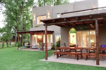 Casa contemporánea con patio, pergola de madera y jardín verde luminoso — proyecto El Encuentro  2, por Marconi Silva Arquitectos, en Benavidez