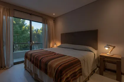Dormitorio rústico moderno con vista al bosque — proyecto Costa Esmeralda 1, por Arquitecto Caceres, en Costa Esmeralda