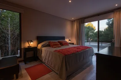 Dormitorio moderno con vista al bosque y luz cálida — proyecto Costa Esmeralda 1, por Arquitecto Caceres, en Costa Esmeralda