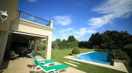 Patio residencial con piscina y vegetación exuberante — proyecto Estancias del Pilar, por ARQCONS, en Pilar