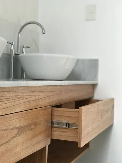 Vanitory de madera clara con bacha redonda y cajon abierto minimalista — proyecto Viamonte, por Biaus Pieres Arquitectura, en CABA