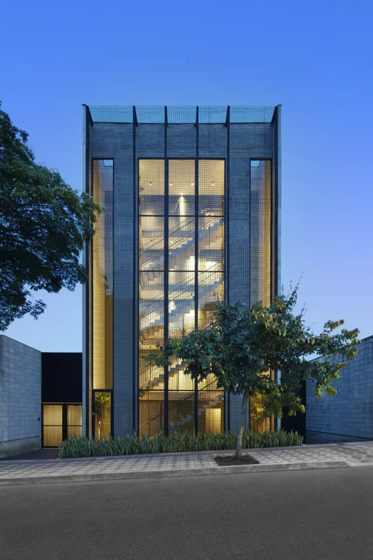 Torre residencial moderna con fachada vidriada y estructura metálica negra — proyecto Edifício Bento, por Trinia Arquitetura