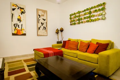 Sala de estar moderna con sofá verde lima y arte abstracto — proyecto La casa del árbol, por Estudio Fernandez Long & asoc., en Canning