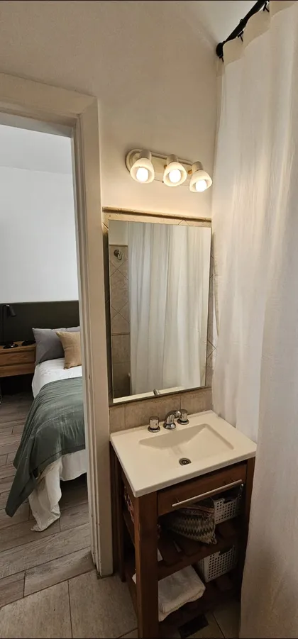 Dormitorio y baño con pisos de madera y estilo rústico moderno — proyecto Callao, por Claraboia , en Recoleta