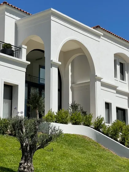 Casa blanca con arcos amplios, jardín y olivo frontal — proyecto CASA LR 456 - SOFITEL LOS CARDALES, por Carolina Depetris, en B2814 Los Cardales