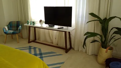 Sala de estar moderna con TV grande y mesa consola — proyecto Casa VG, por Vicky Hurrell, en Mar del Plata