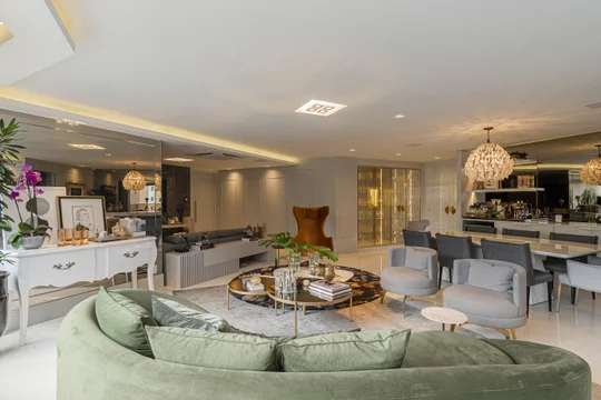 Living moderno con sofa verde, marmol y grandes ventanales luminosos — proyecto Projeto 1, por Studiok