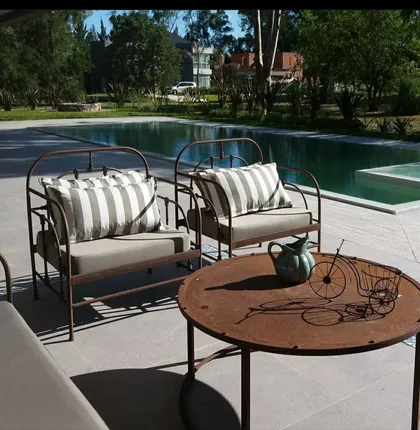 Living exterior moderno con piscina y sillones a rayas — proyecto Caning, por Decortinasytelas, en Buenos Aires
