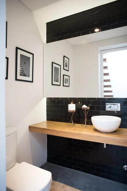 Baño moderno con mesada flotante de madera y bacha redonda — proyecto Ravignani, por Estudio Basa, en Palermo