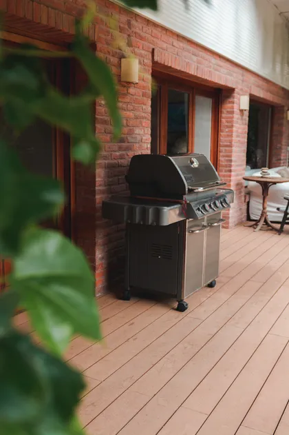 Parrilla moderna en deck de madera con pared de ladrillo a la vista — proyecto Proyecto San Isidro Chico, por Alpa Mat, en San Isidro