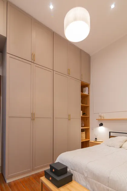 dormitorio moderno con armario empotrado y cama a rayas — proyecto Anchorena, por Martina Kleinert, en Palermo