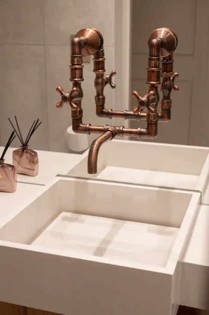 Grifería de cobre estilo industrial sobre lavabo blanco de microcemento — proyecto LIBERTADOR DANDY, por AB ARQUITECTURA, en Recoleta