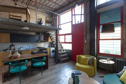 Living moderno industrial con ladrillos expuestos y doble altura — proyecto Casa Arcos, por Silvia Soqueff, en Núñez