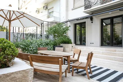 Patio contemporáneo con comedor de madera y jardín con sombrilla — proyecto ARQ. TOMAS MAGRANE, por uchimayfotos, en CABA