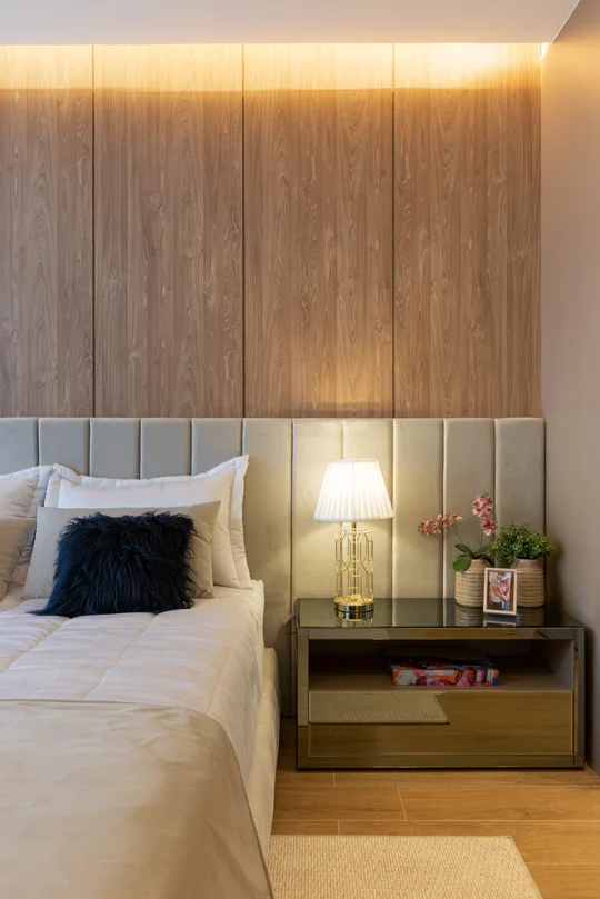Dormitorio contemporáneo con cabecero tapizado y pared revestida en madera — proyecto Decorados Vitória, por Pricila Dalzochio