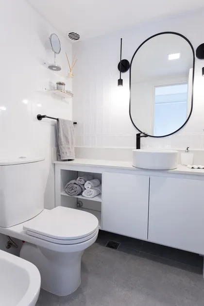 Baño moderno con lavabo redondo y espejo ovalado — proyecto Obra Clay, por SYA Arquitectas, en Palermo