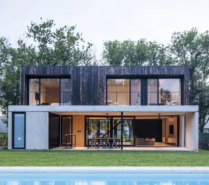 Casa moderna con fachada de madera oscura, vidrio y piscina — proyecto Black House, por V2 Arquitectos, en City Bell