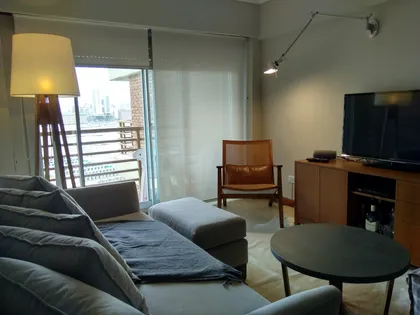 Living moderno con sofá modular y lámpara de pie — proyecto Departamento RA, por Vicky Hurrell, en Mar del Plata