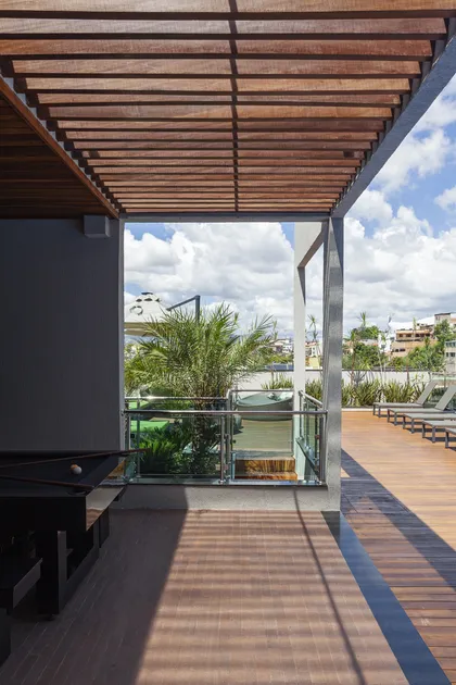 Terraza con pergola de madera y vistas a la ciudad — proyecto CASA BH, por Frederico Bicalho Arquitetura