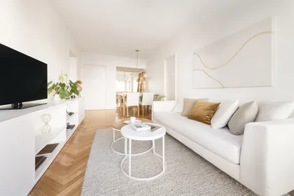 Sala de estar moderna con sofá blanco modular y suelo de madera — proyecto Cerviño, por Estudio Basa, en CABA