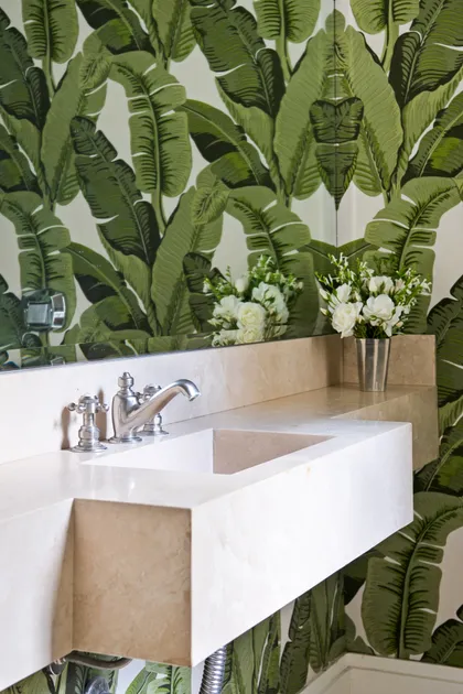 Baño moderno con mesada marmol blanca y papel tapiz hojas verdes — proyecto La Chacra , por Estudio Du