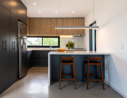 Cocina moderna abierta con isla central y barra — proyecto Santa Isabel - Andrea Gonzalez, por ABEJA CONCEPT, en Nordelta