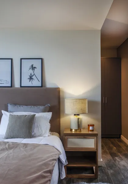 Dormitorio moderno con cama doble, detalles botánicos y luz cálida — proyecto Casa BJM, por Vanguarda Arquitectos, en Belén de Escobar