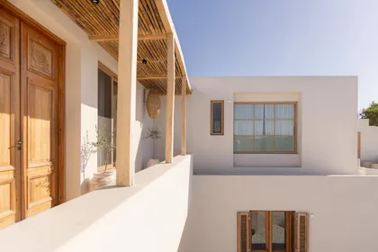 Terraza de estilo mediterráneo moderno con techo de madera y vista al mar — proyecto El Refugio, por Grupo Pauta Arquitectura, en Pinamar