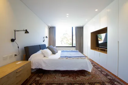 Dormitorio moderno con armario empotrado y alfombra ornamental — proyecto CASA BPO, por radovic_arquitecto, en San Isidro