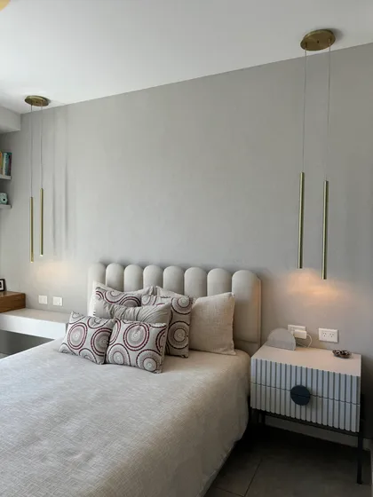 Dormitorio moderno con luces colgantes y cama con respaldo capitoné — proyecto Freire, por MDBK Arquitectura, en Belgrano