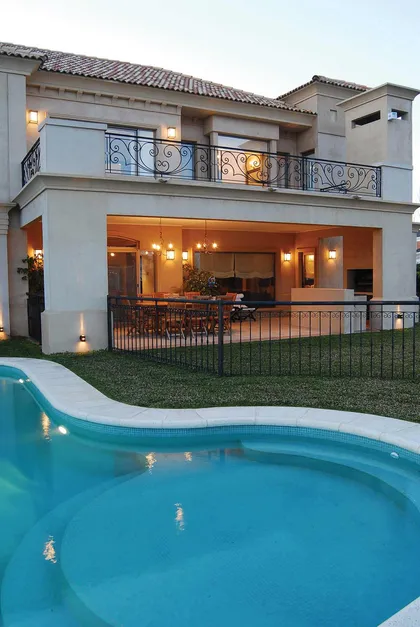 Casa moderna con pileta, galeria iluminada y jardin al atardecer — proyecto Campiña Italiana, por Ciba Arquitectura