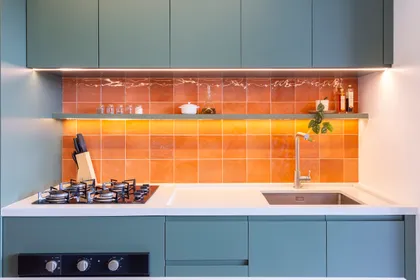 Cocina minimalista con azulejos naranjas, mesada blanca y muebles azul grisáceo — proyecto #ApêCoolColors, por Oficina de Morar, en Jaraguá do Sul - Barra do Rio do Cerro