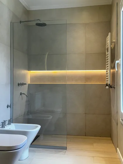 Baño moderno con bidet, inodoro, ducha de vidrio y luz indirecta — proyecto CASA LA LOMADA , por Estudio Grupo 32, en Pilar