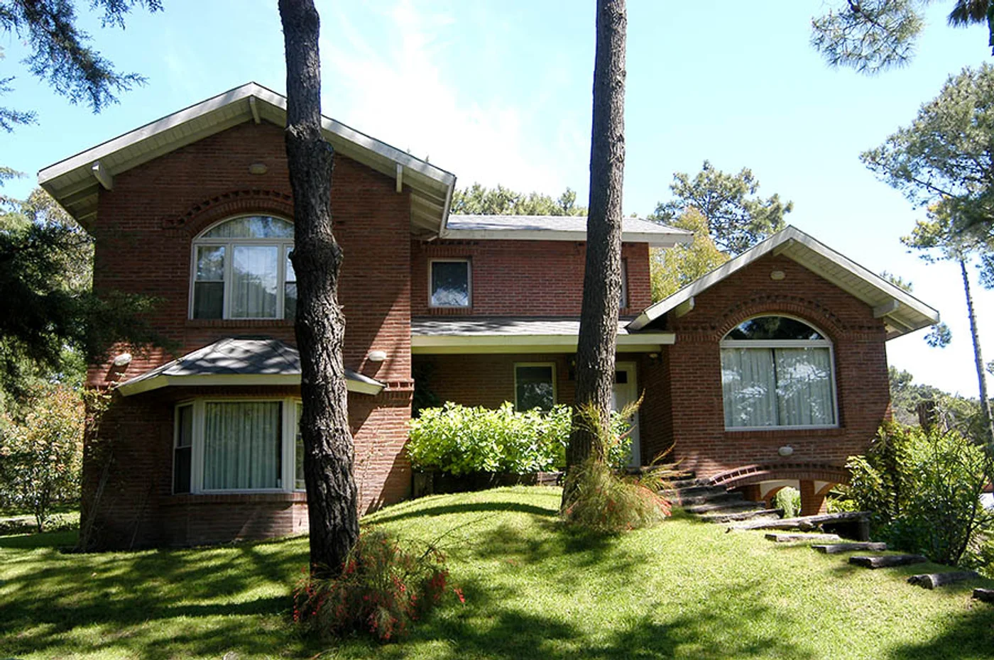 fachada de casa moderna con ladrillo visto y grandes ventanales