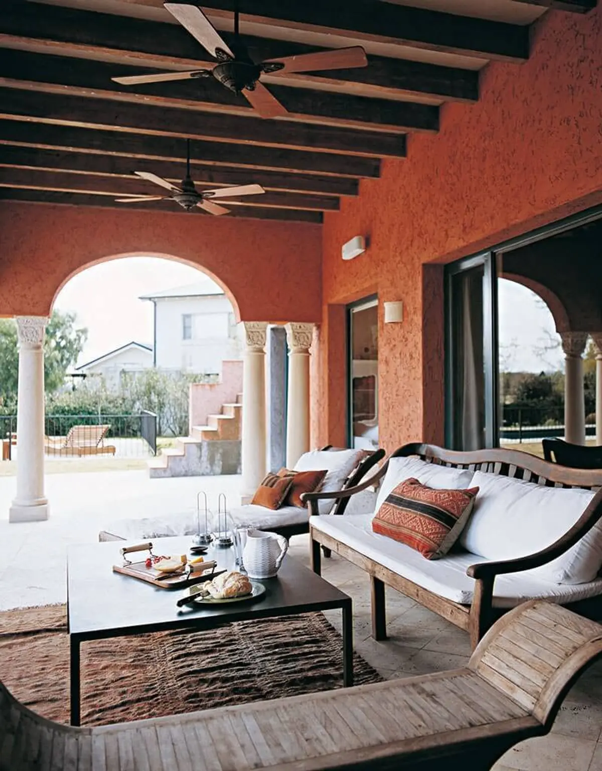 Patio mediterráneo con vigas de madera y muebles de exterior — proyecto Las Arcadas, por Ricardo Pereyra Iraola 