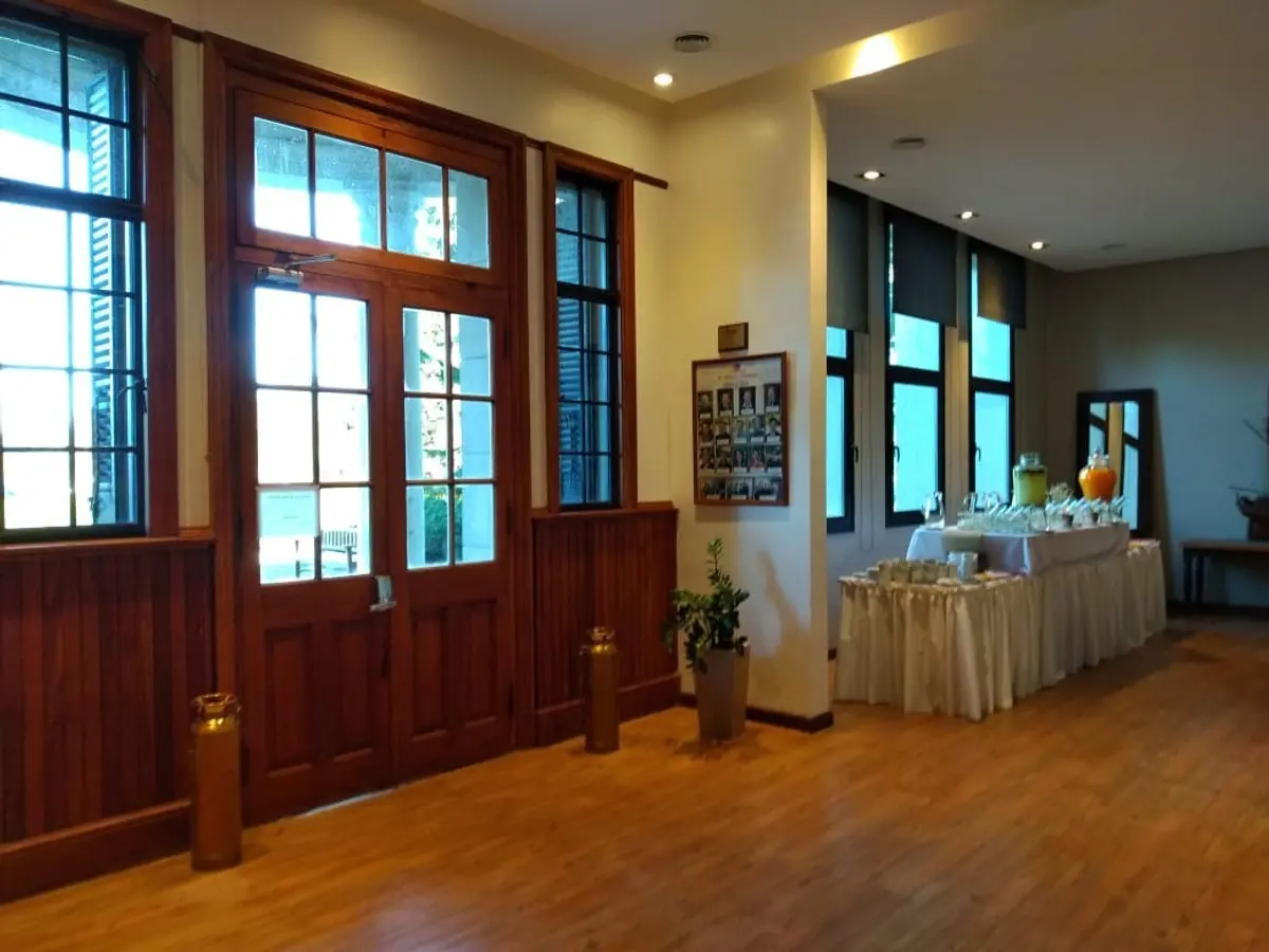 Pasillo de hotel con puertas de madera y buffet — proyecto St George´s College Quilmes Edificio Boarding House, por byb.arquitectas, en Quilmes