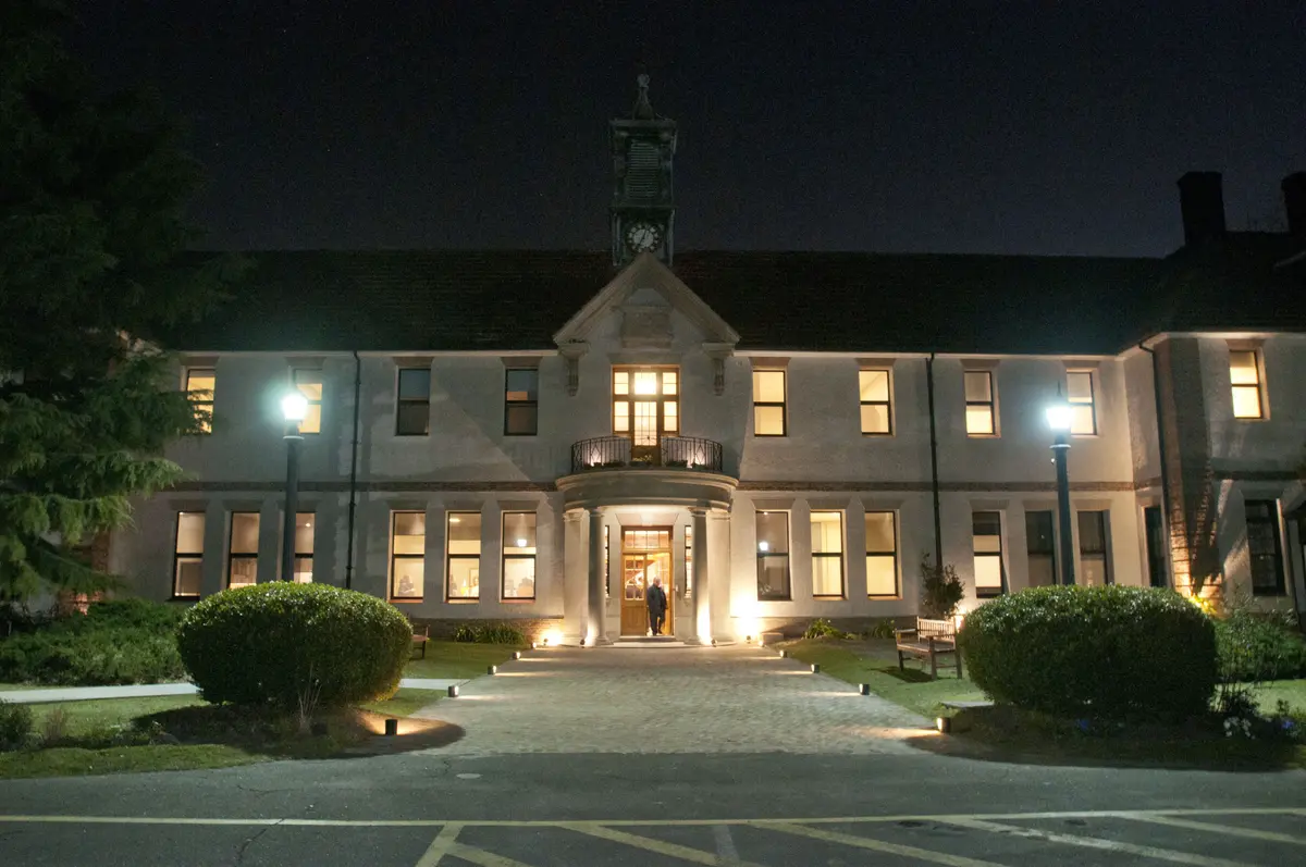 fachada clássica de prédio com arcos iluminada à noite — projeto St George´s College Quilmes Edificio Boarding House, por byb.arquitectas, em Quilmes