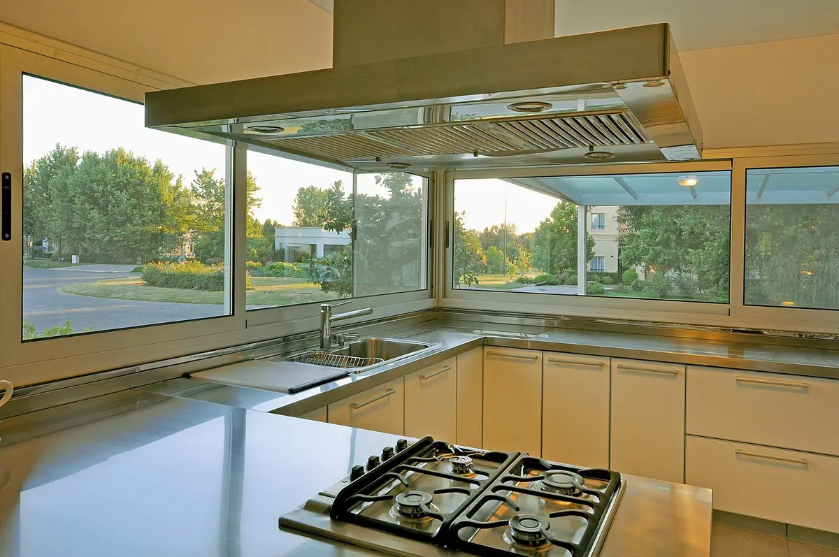 Cozinha moderna com janela panorâmica e armários brancos — projeto Casa 10, por Estudio Martínez Nespral