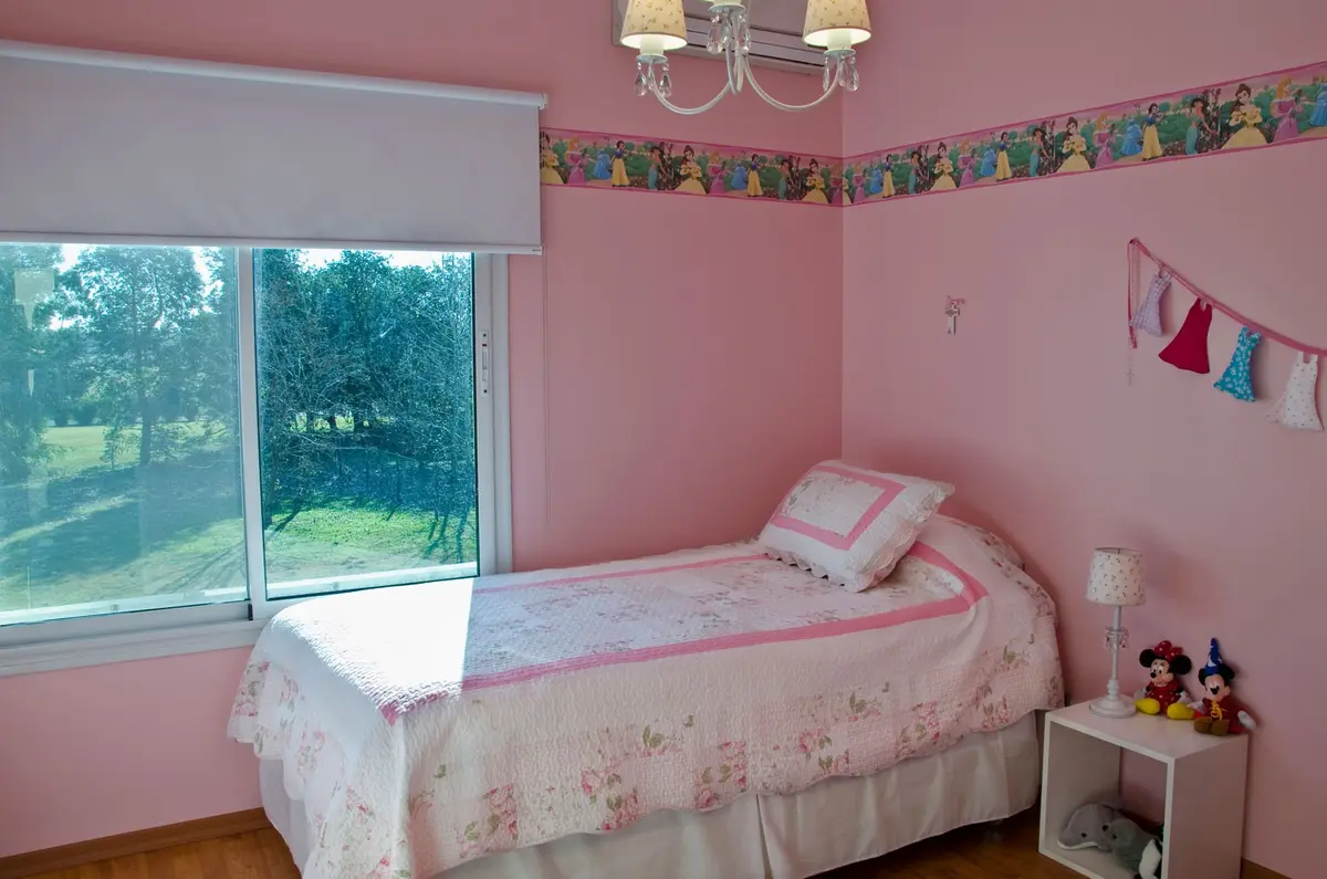 Quarto infantil rosa com cama, janela para jardim — projeto Casa 7, por Estudio Martínez Nespral