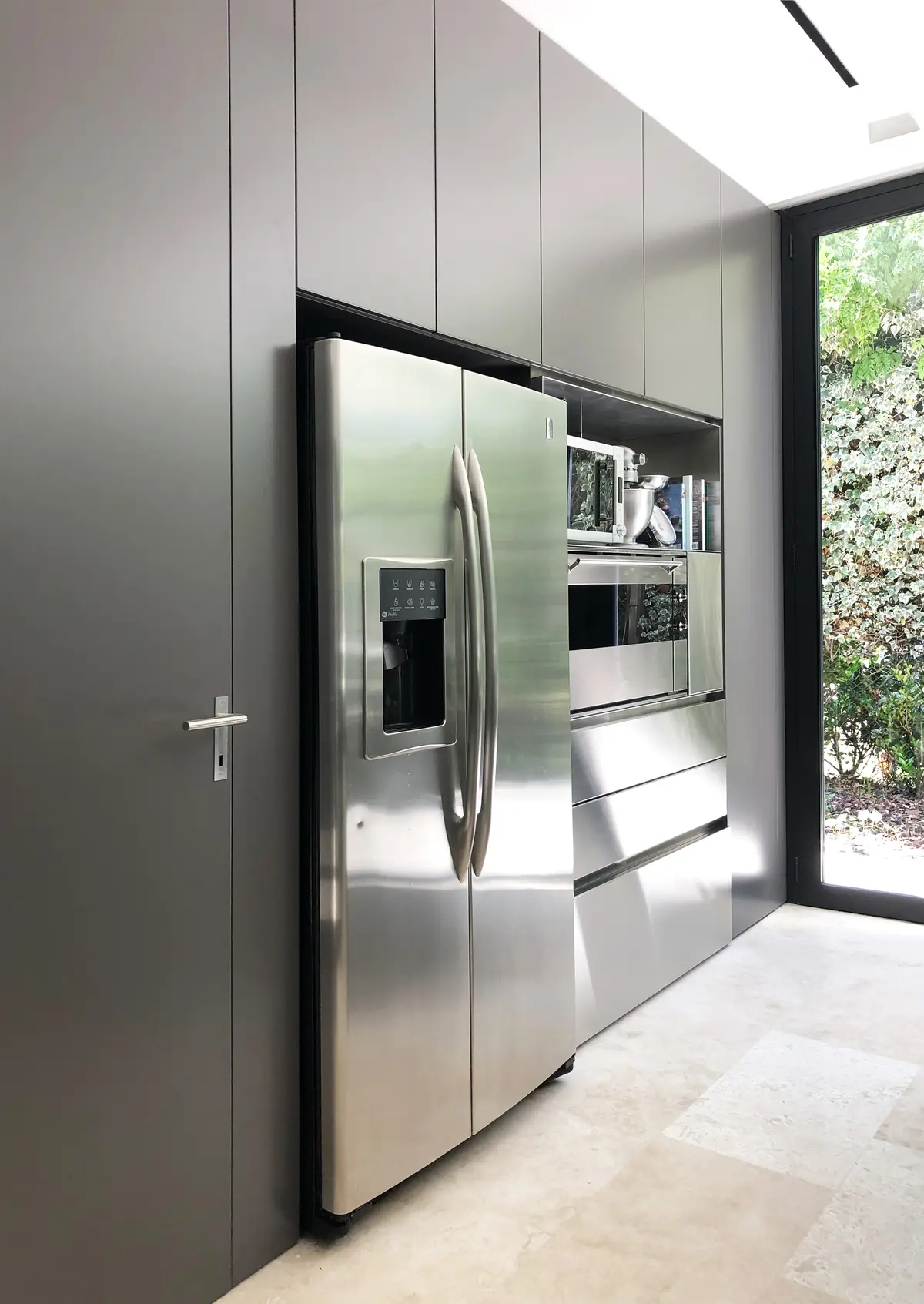 Cozinha moderna minimalista com eletrodomésticos embutidos e janela grande — projeto Las Lomas, por Estudio MMS, em San Isidro