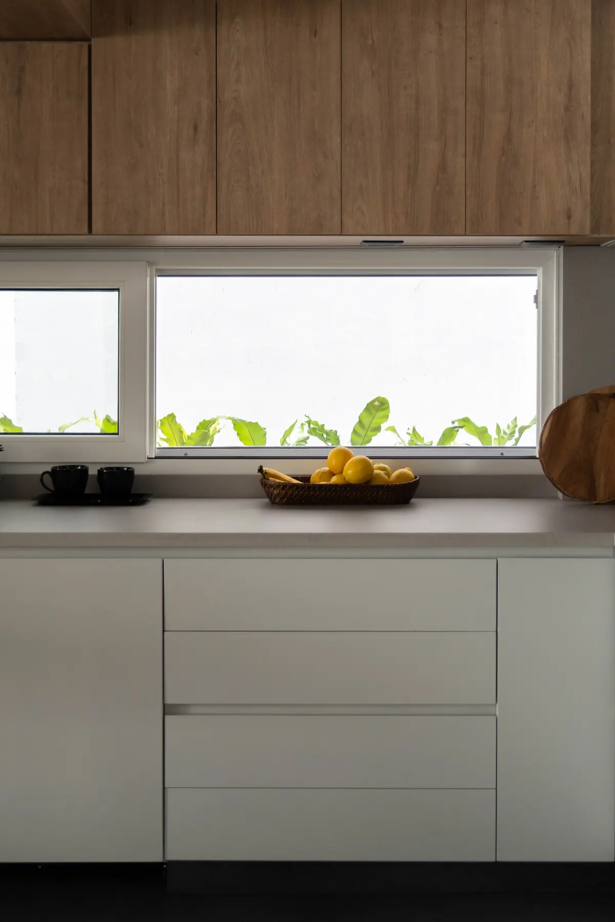 Cocina moderna escandinava con muebles de madera y cajones blancos — proyecto Figueroa Alcorta, por JT ARQUITECTURA, en CABA