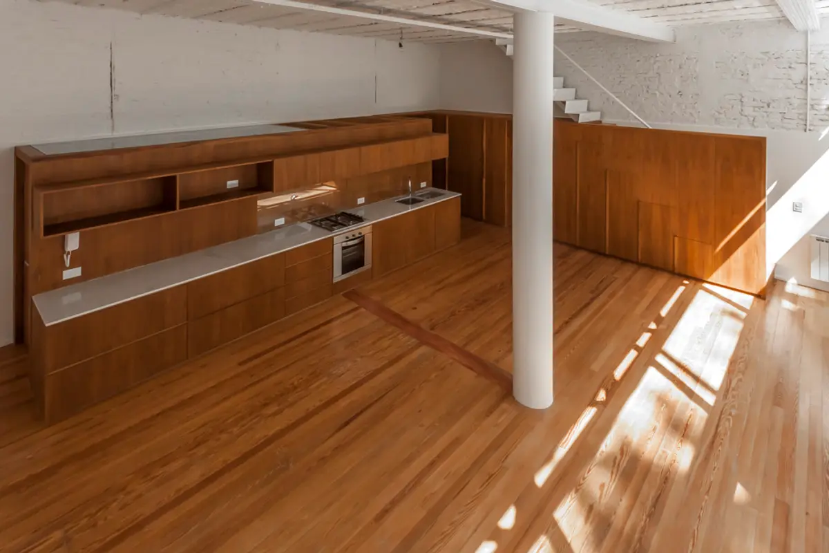 Cozinha moderna com pé-direito duplo e painéis de madeira — projeto PH Tamborini, por ariana werber arquitecta, em Núñez
