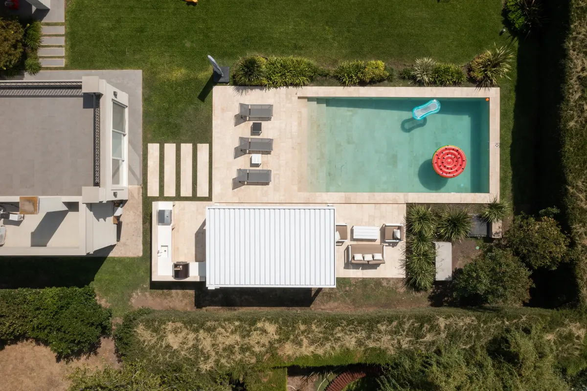 Ampla vista aérea de piscina moderna com deck e área de estar externa — projeto TOLDER - PERGOLAS, por Argentina en Obra 2024, em Rincón de Milberg