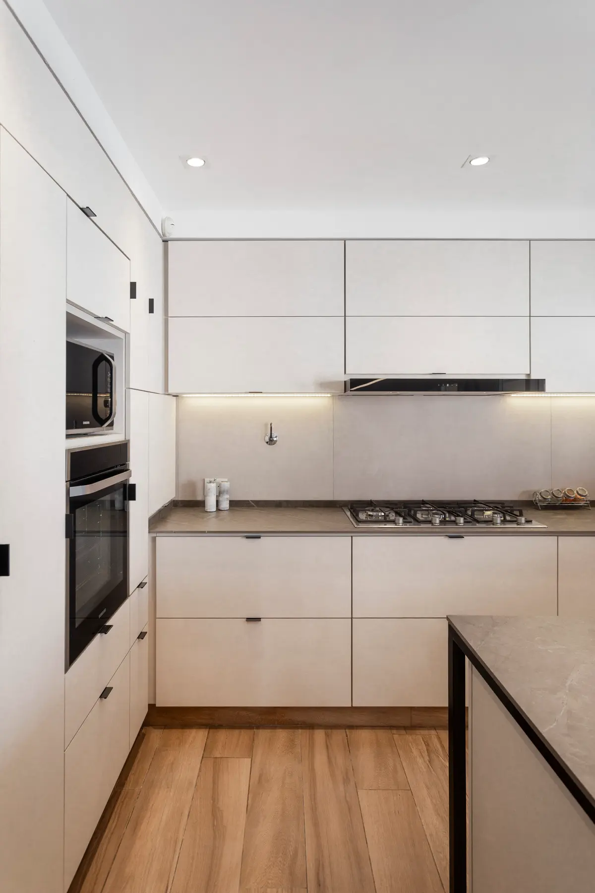 Cozinha moderna escandinava com armários minimalistas e iluminação indireta — projeto Casa en Martinez, por JT ARQUITECTURA, em Martínez
