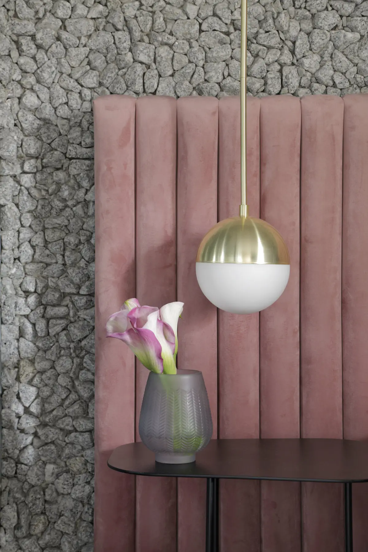 Lámpara colgante dorada con esfera blanca ante pared de piedra gris — proyecto Casa COR 2019, por Studio Ro-ca