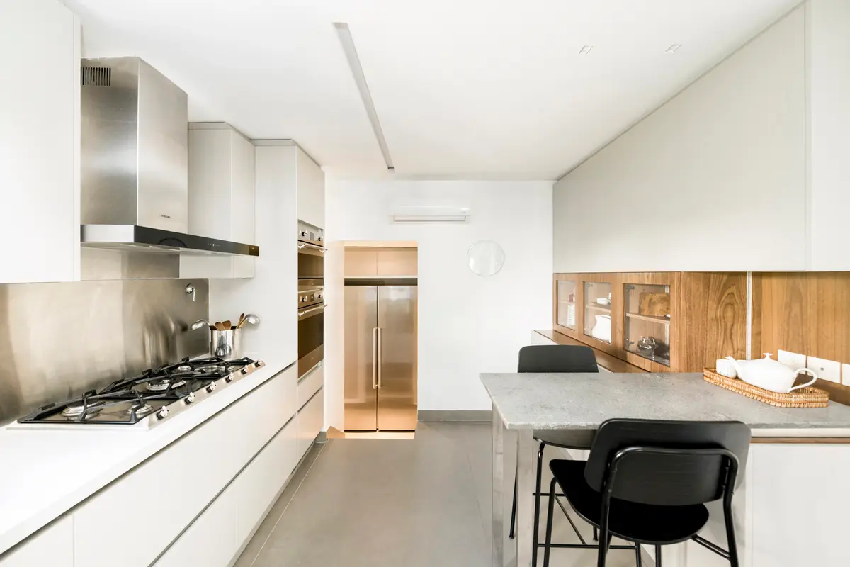 Cozinha moderna minimalista com ilha e eletrodomésticos embutidos — projeto Boating Club, por SRMD Arquitectura, em Boating Club